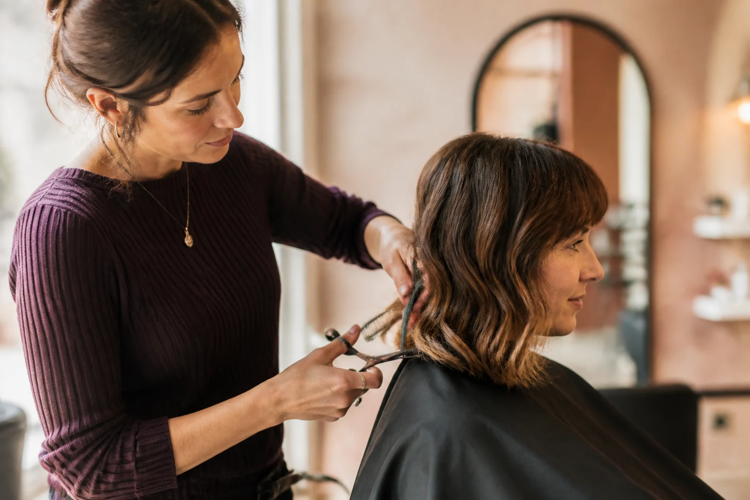 Fictional stylist finishing a textured haircut
